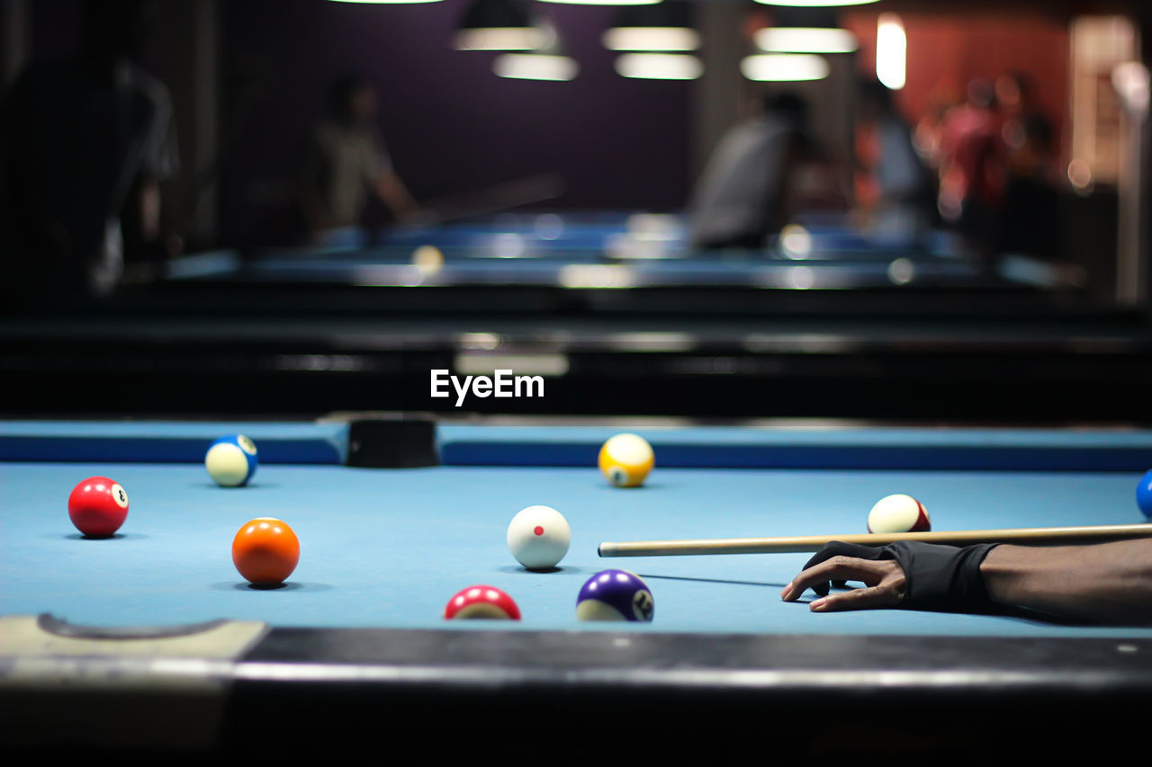 Cropped hand of man playing snooker