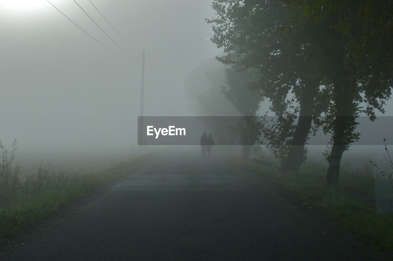 People on road during foggy weather