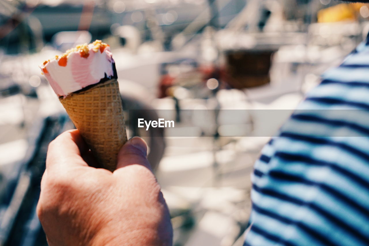 Cropped hand of man holding ice cream cone