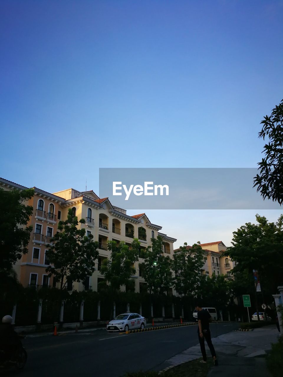 CARS ON ROAD AGAINST BUILDINGS