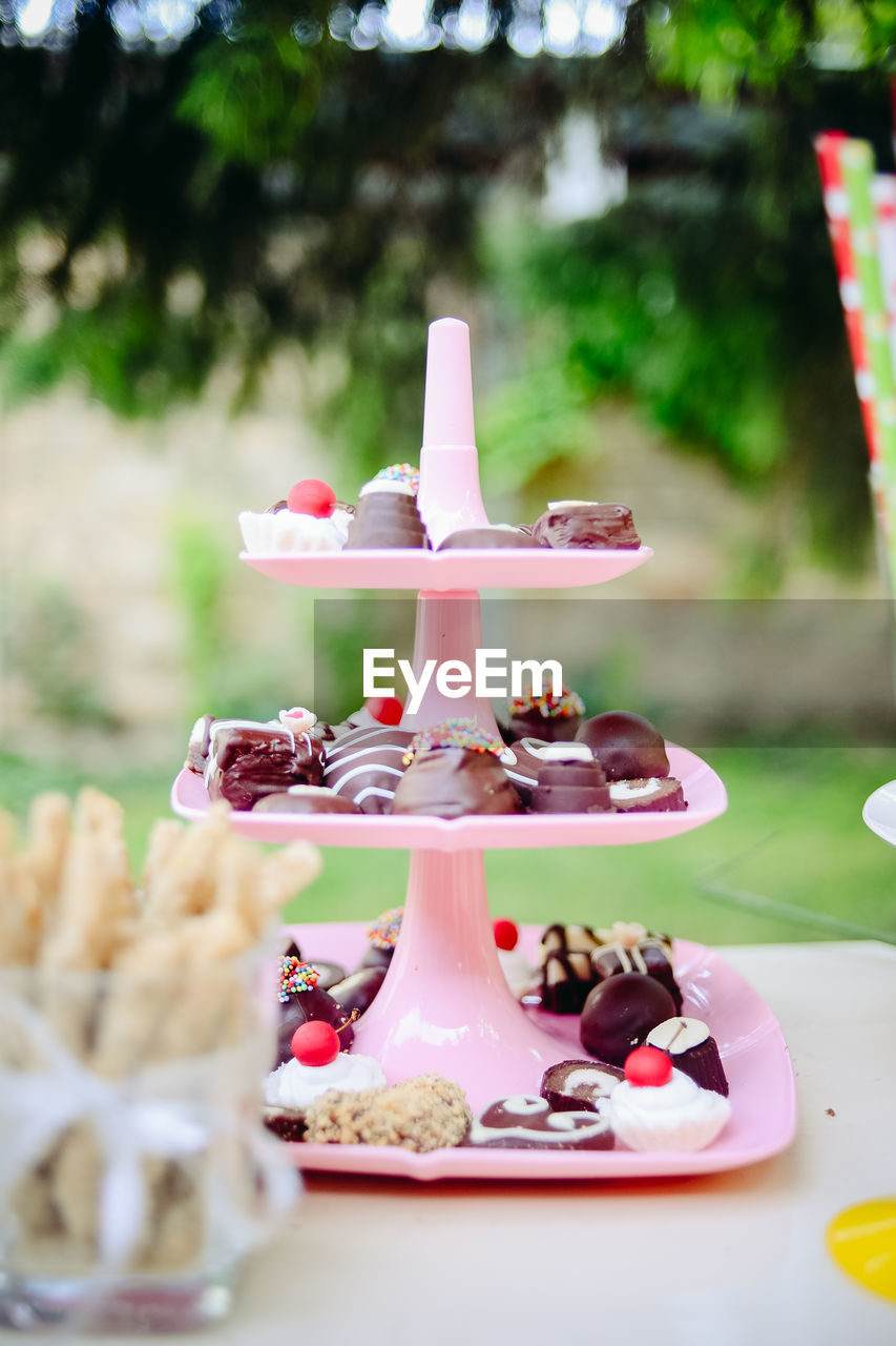 Variety of desserts in cakestand on table