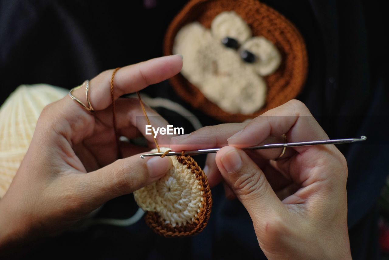 Close-up of skilled hands making crafts from knitting yarn