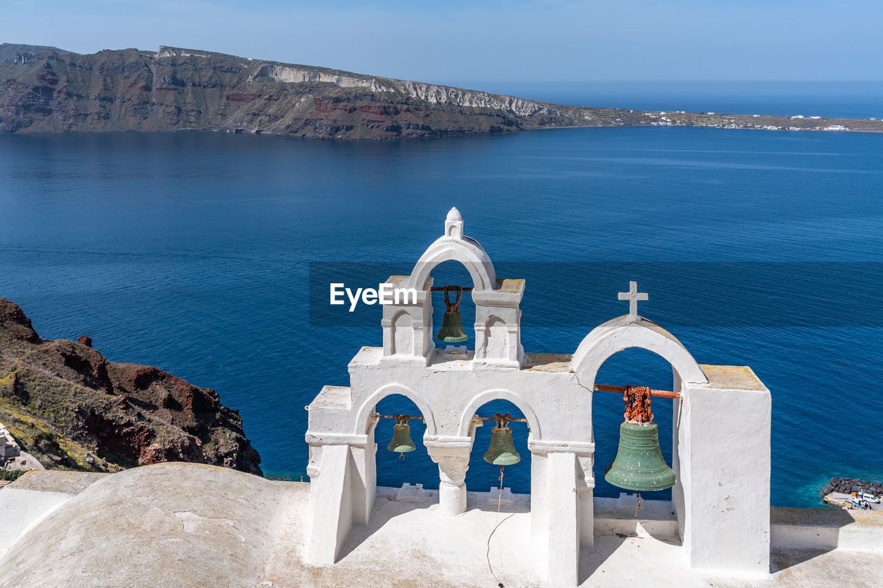 Typical church in oia overlooking the mediterranean sea, santorini, greece