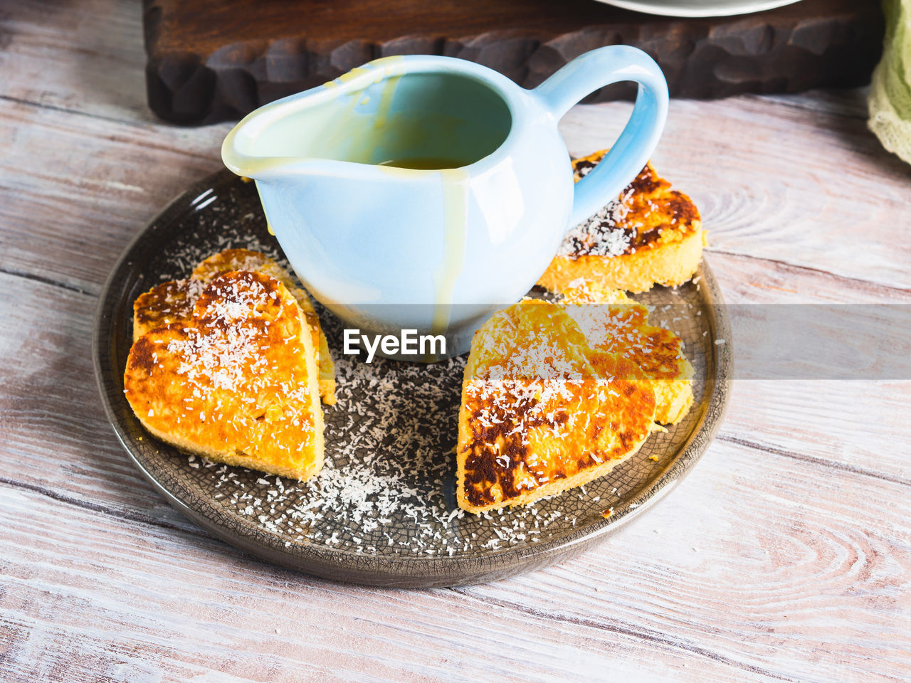 CLOSE-UP OF COFFEE CUP ON TABLE WITH SPOON