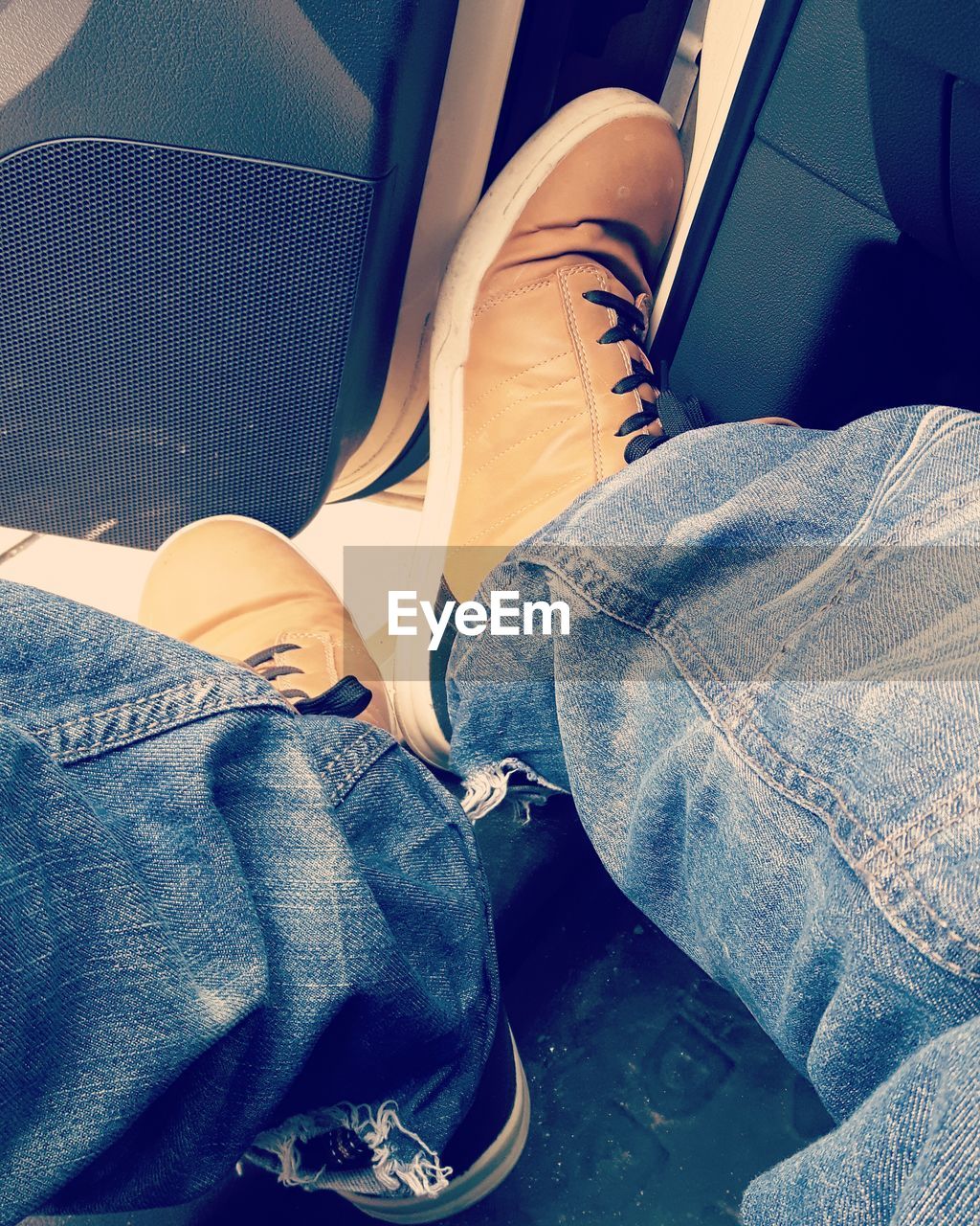 LOW SECTION OF MAN SITTING ON SEAT IN CAR