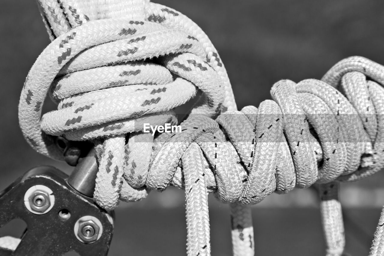 CLOSE-UP OF ROPES TIED UP METAL