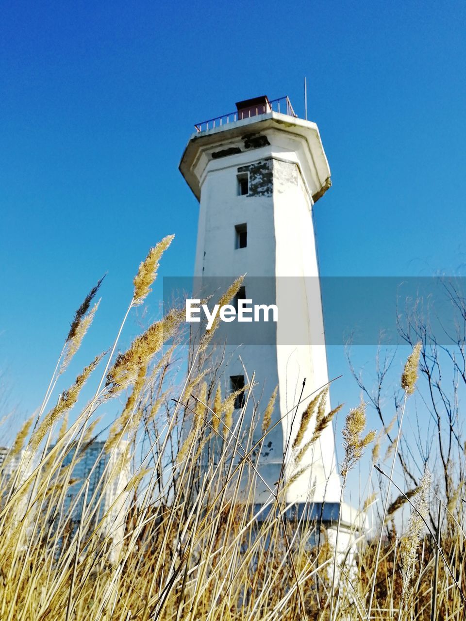 LOW ANGLE VIEW OF LIGHTHOUSE AGAINST CLEAR BLUE SKY