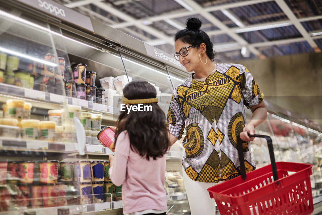Mother with daughter in supermarket