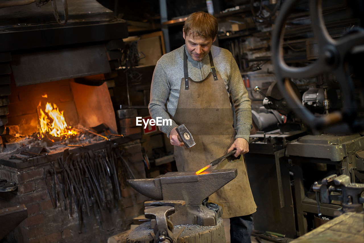 Blacksmith working in workshop