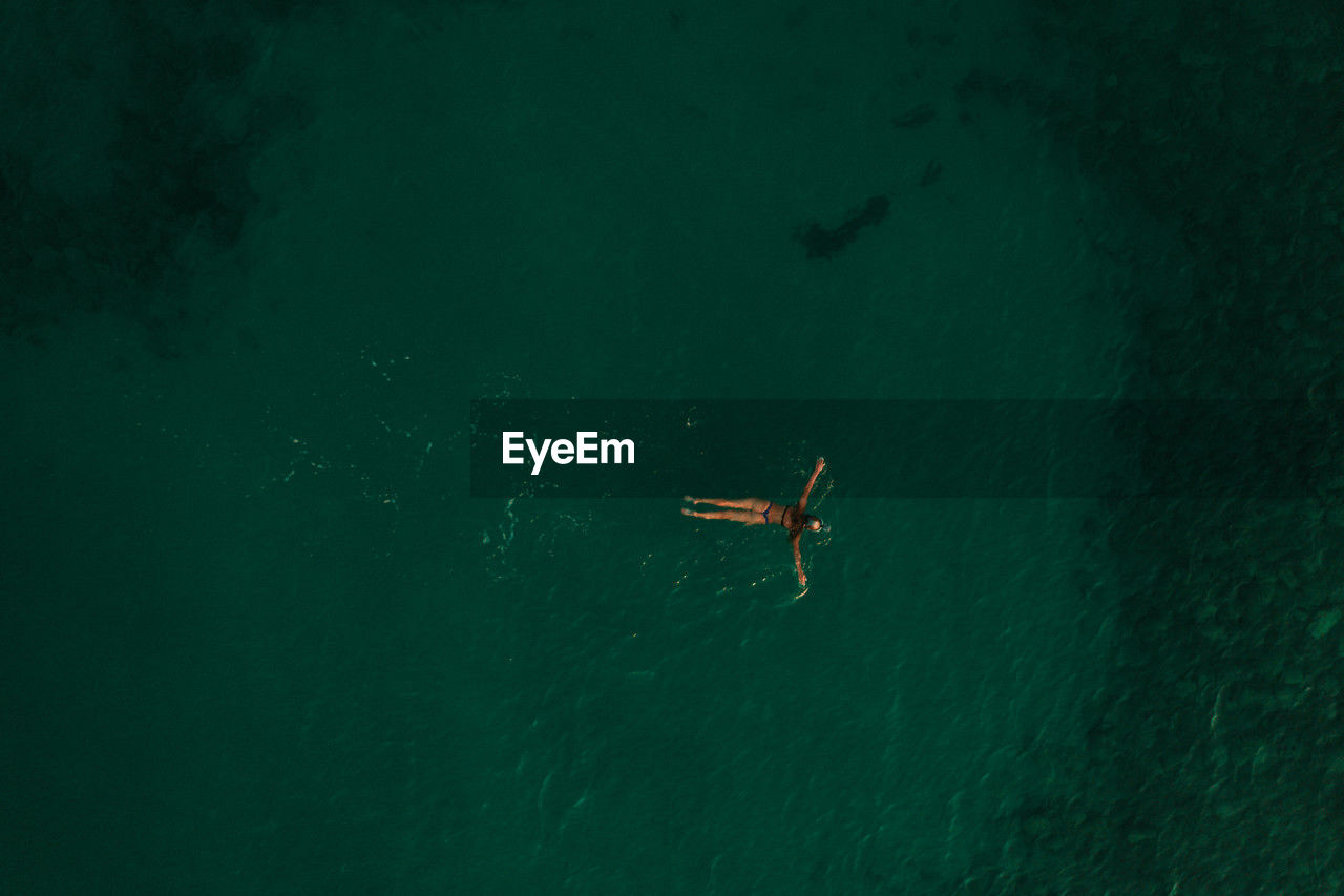 high angle view of person swimming in sea