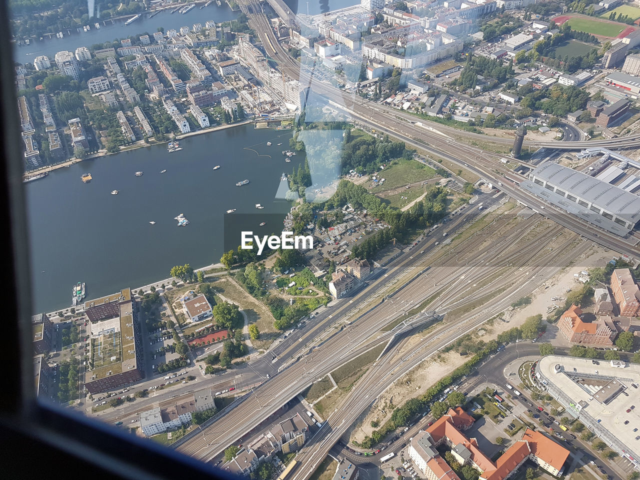 HIGH ANGLE VIEW OF CITY BUILDINGS SEEN THROUGH GLASS WINDOW