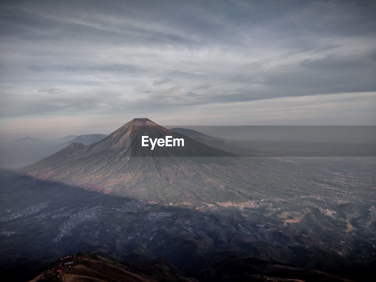 View of volcanic landscape against cloudy sky