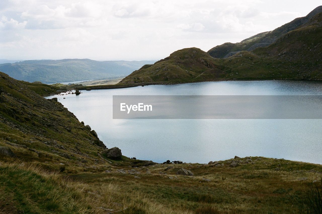 Scenic view of lake and mountains against sky