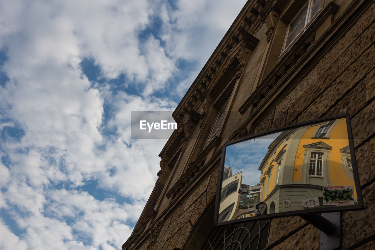 LOW ANGLE VIEW OF BUILDING AGAINST CLOUDY SKY