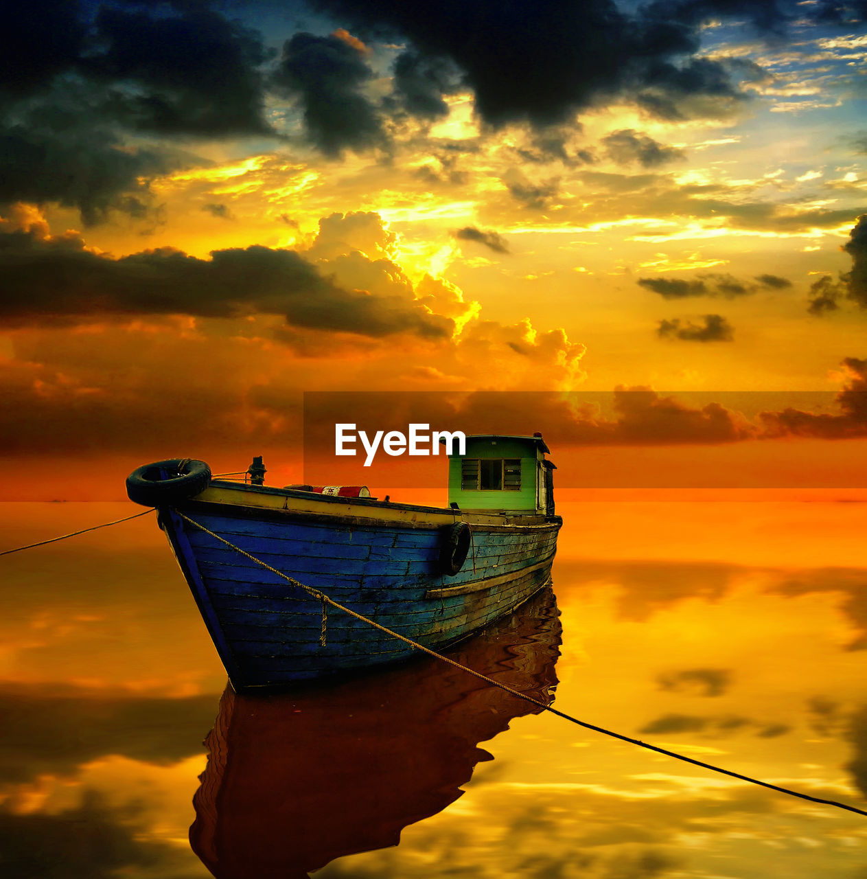 FISHING BOAT MOORED ON SEA AGAINST SKY DURING SUNSET