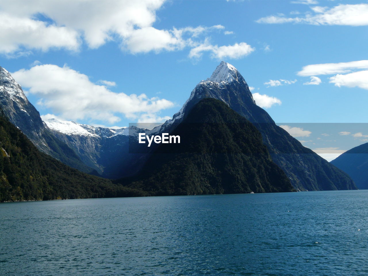 Calm lake against mountain range