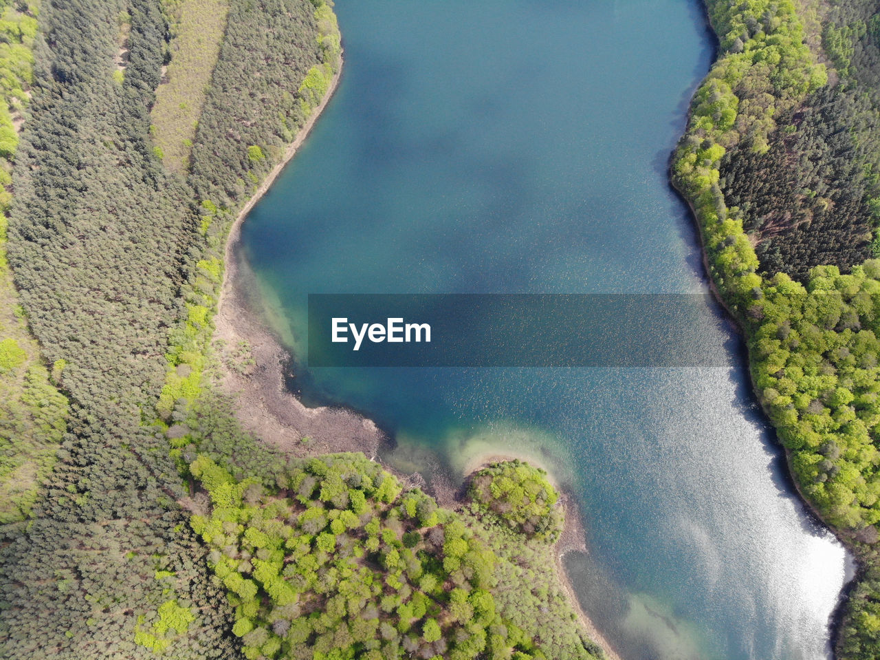Aerial view of crystal clear peetschsee located in stechlin conservation area, brandenburg germany