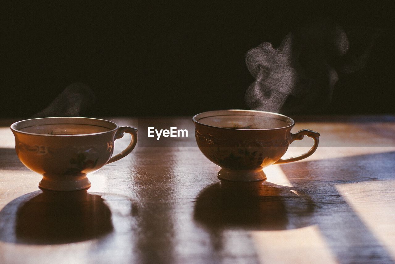 Close-up of cups of steaming tea