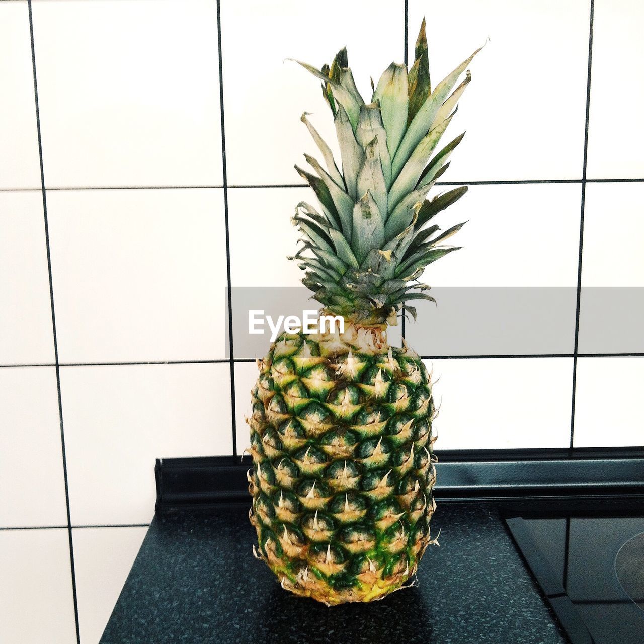 Close-up of pineapple on kitchen counter