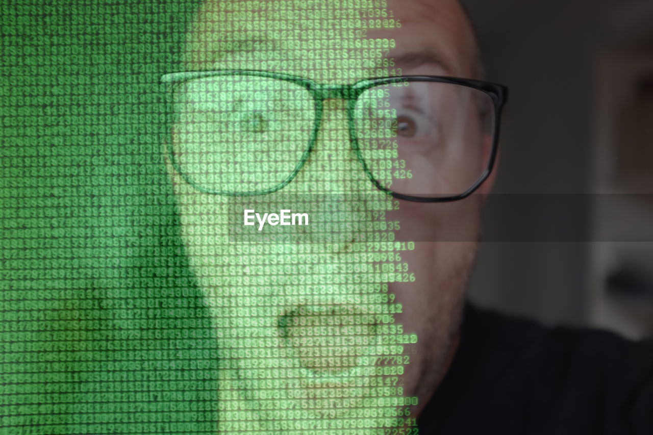 Digital composite image of shocked man against computer language