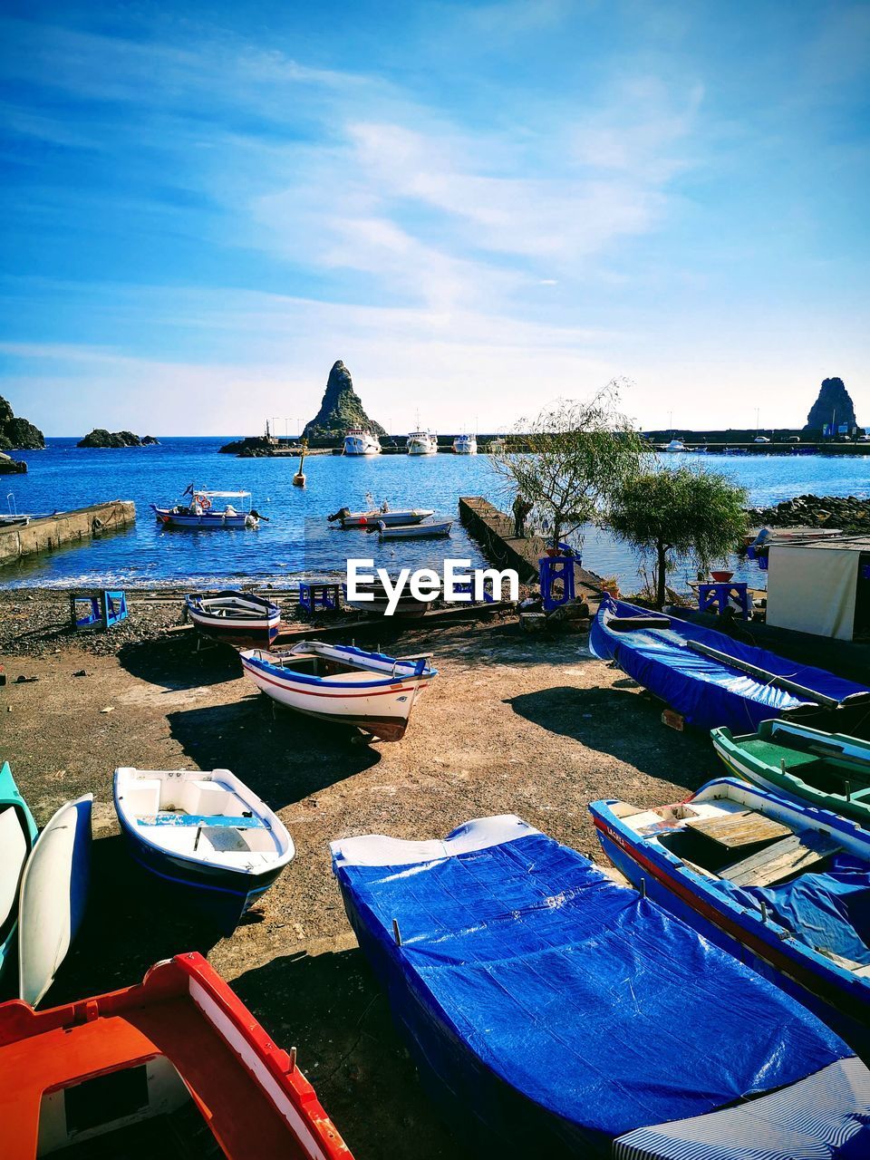 BOATS MOORED ON SEA AGAINST SKY