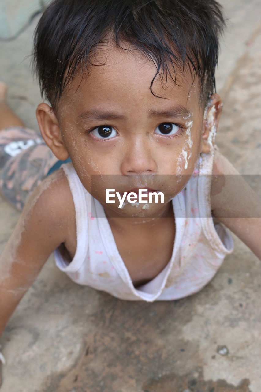 Close-up portrait of cute boy with messy face