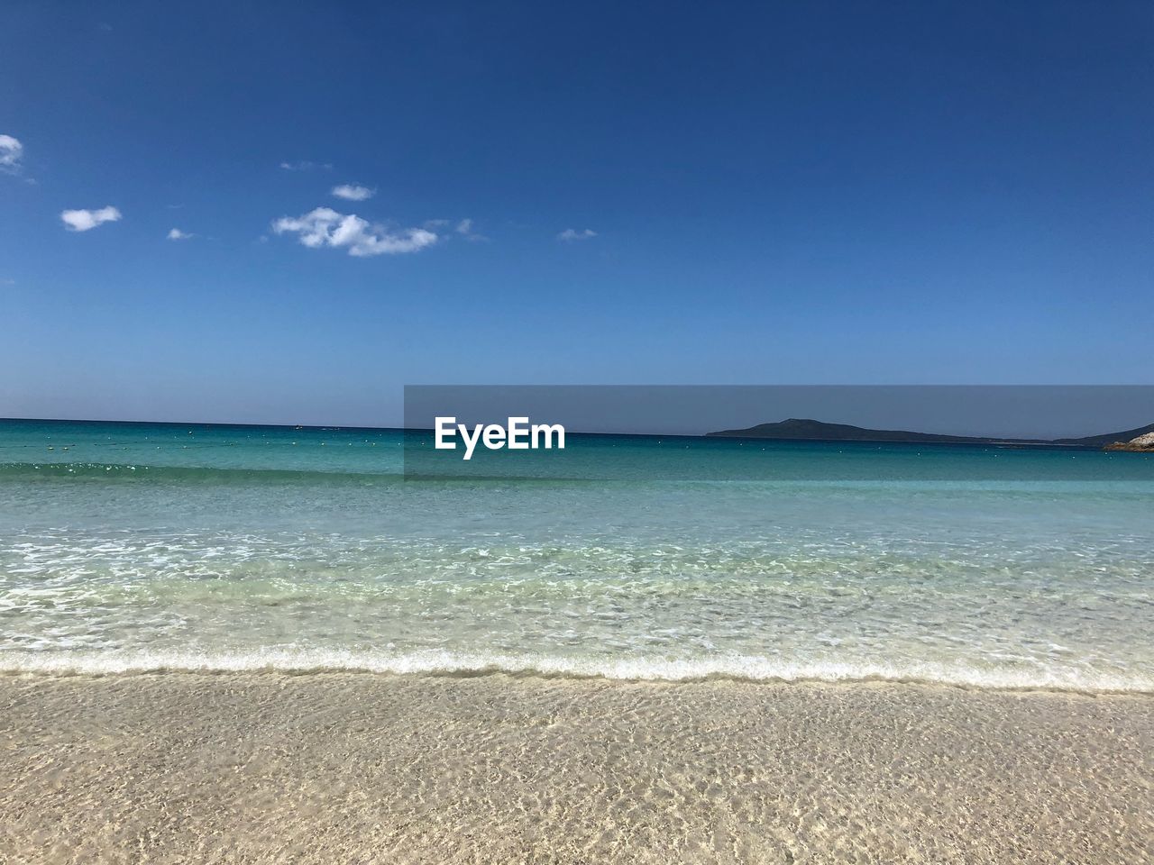 SCENIC VIEW OF BEACH AGAINST BLUE SKY