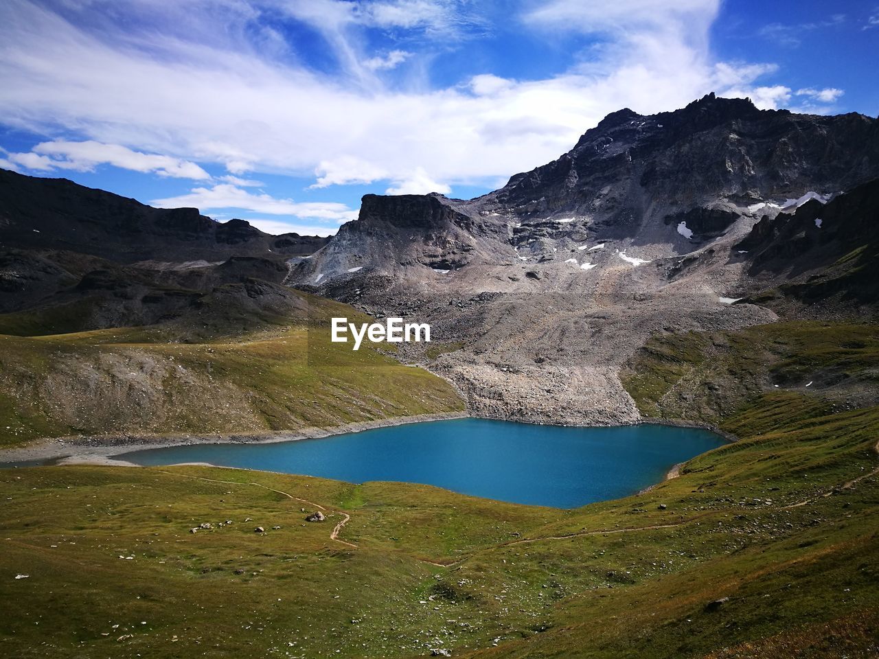 Scenic view of lake and mountains against sky