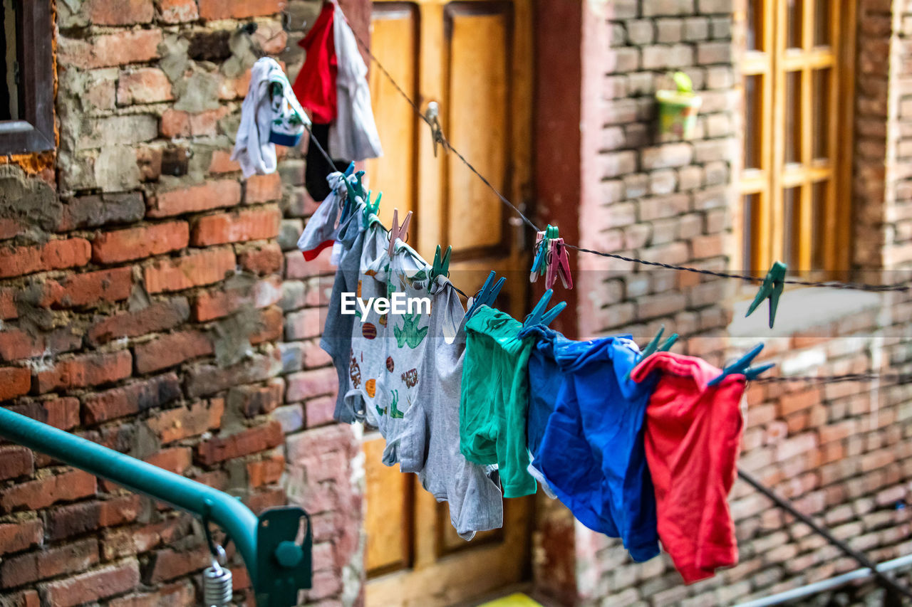 CLOTHES DRYING AGAINST WALL