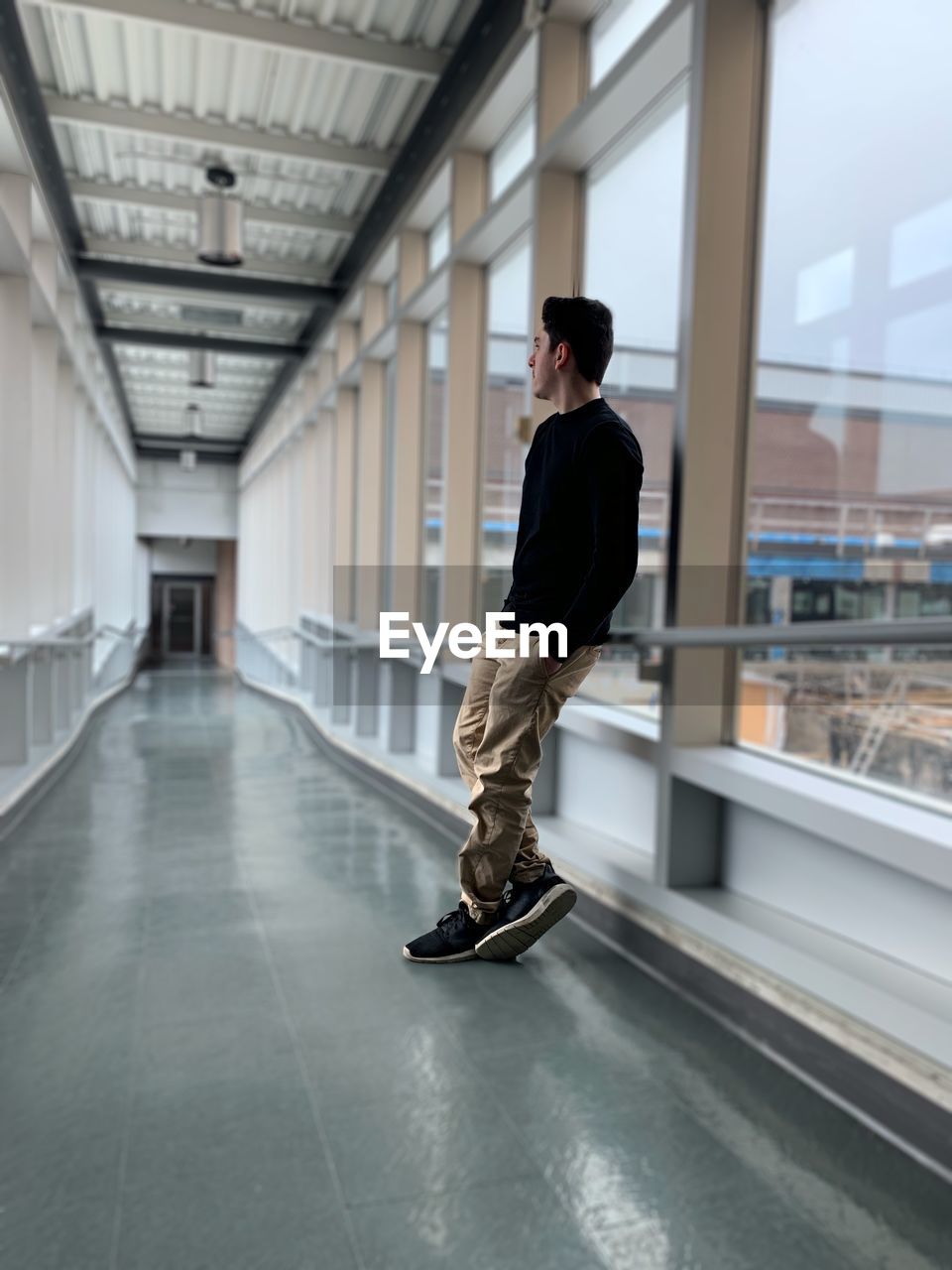 Full length of young man standing in corridor