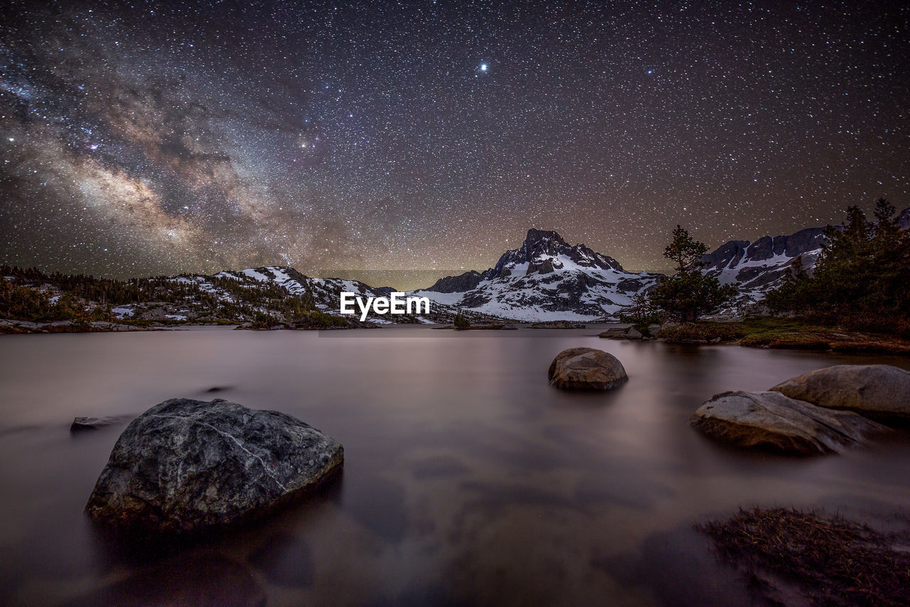 Scenic view of lake against sky at night