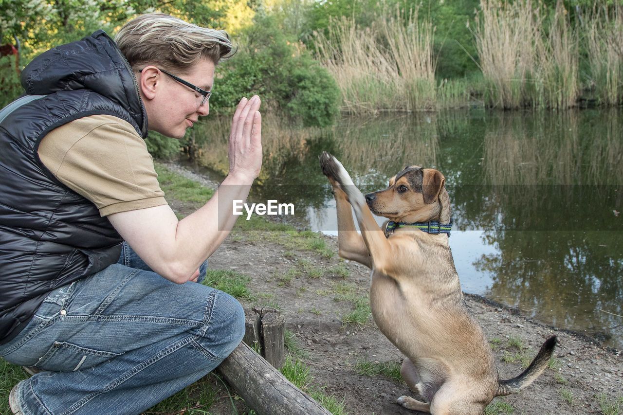 Man doing high five with dog