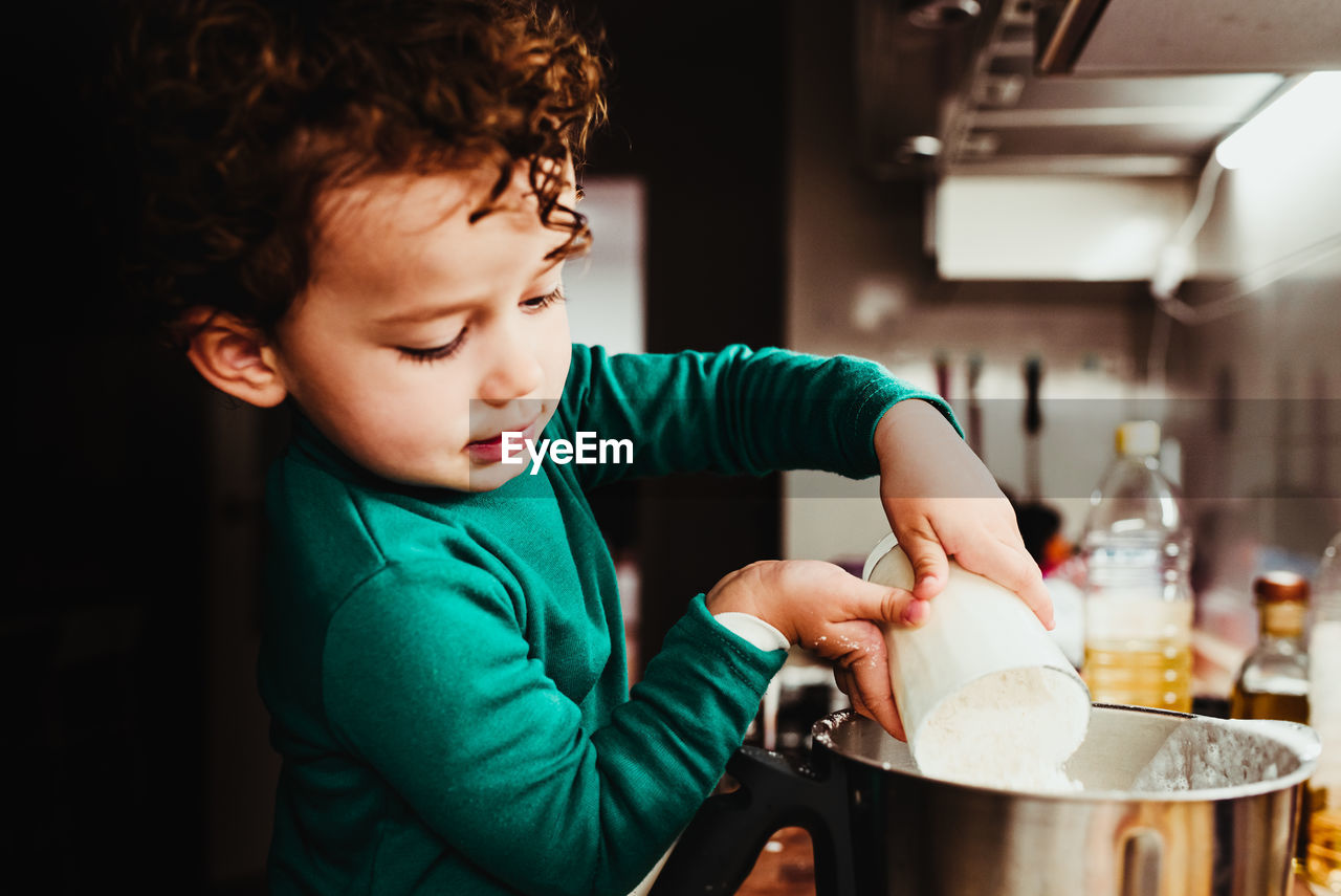 Boy holding ice cream at home