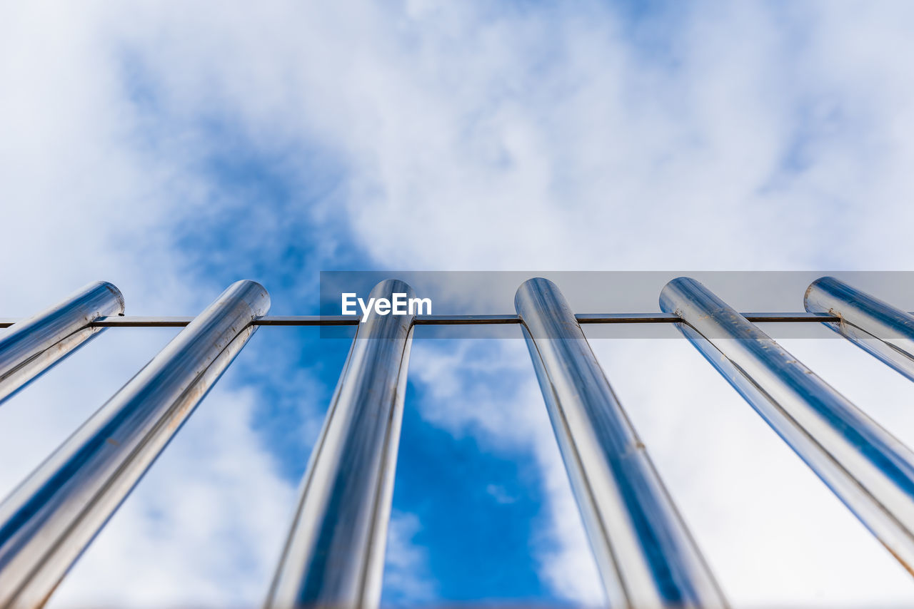 LOW ANGLE VIEW OF BRIDGE AGAINST CLOUDY SKY