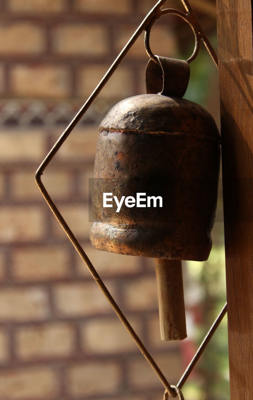 Close-up of bell hanging indoors