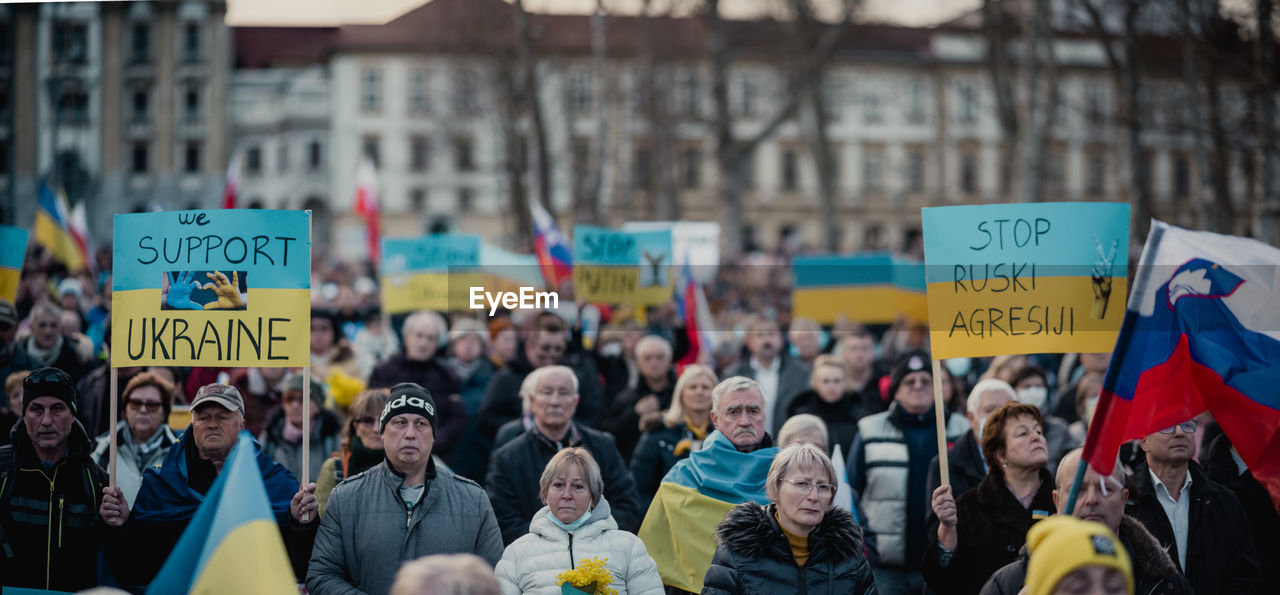 crowd, protest, group of people, large group of people, education, communication, adult, protestor, women, men, city, flag, day, architecture, text, social issues, street, outdoors, unity, banner, politics, placard, sign