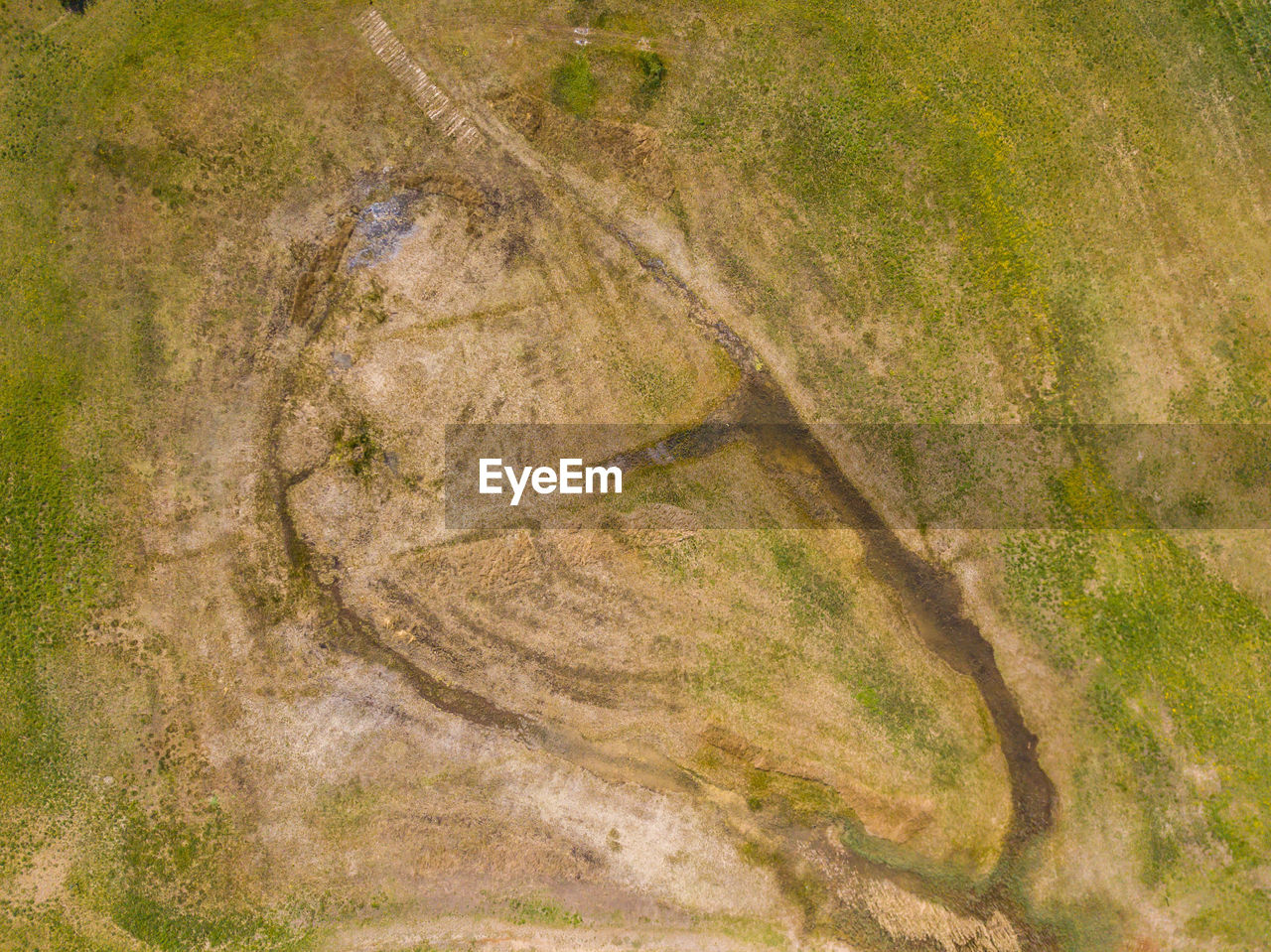 HIGH ANGLE VIEW OF WATER FLOWING ON LAND