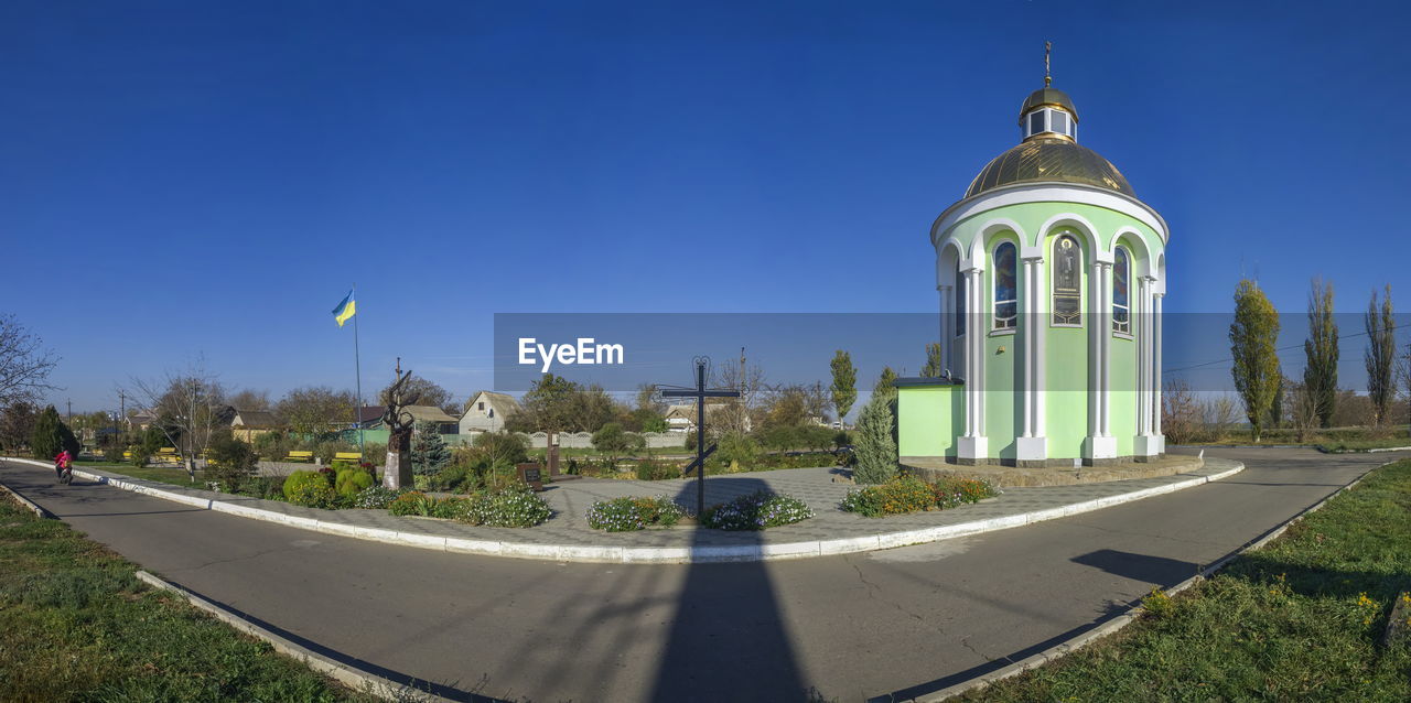 PANORAMIC SHOT OF BUILDINGS AGAINST BLUE SKY