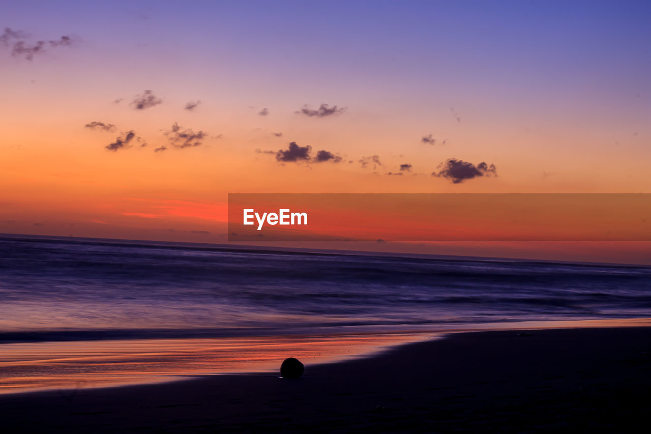 SCENIC VIEW OF SUNSET OVER SEA