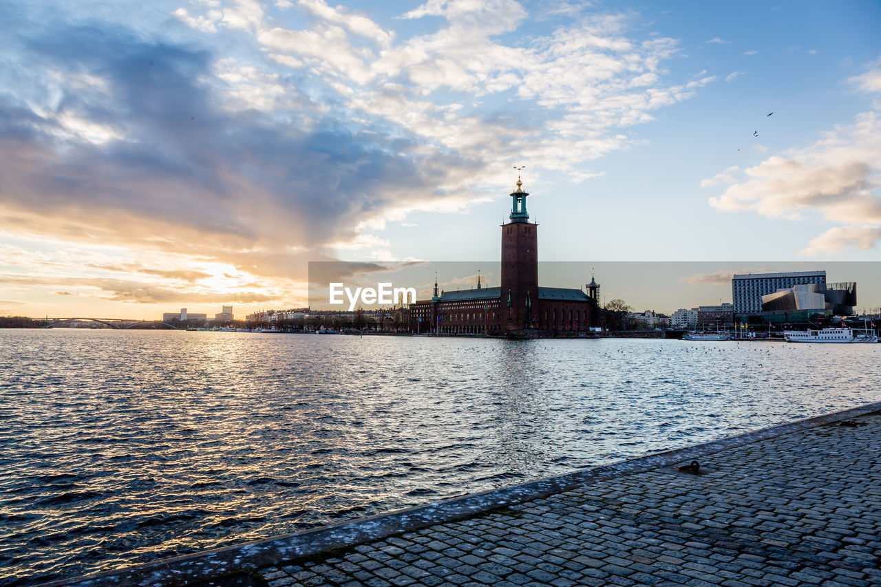 Kungsholmen town hall in city by riddarfjarden during sunset