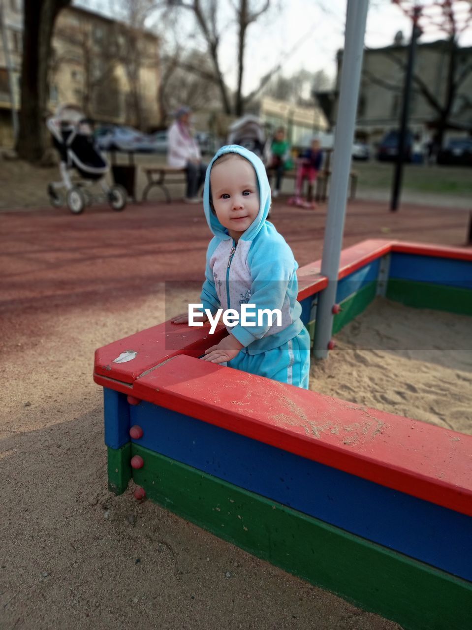 Portrait of cute baby girl playing in playground