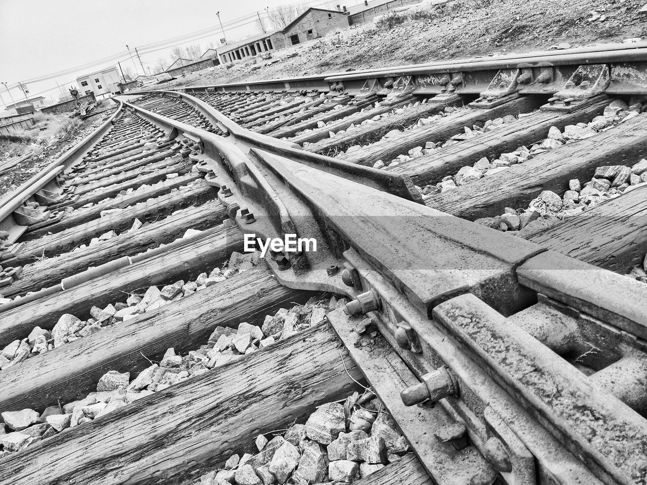 HIGH ANGLE VIEW OF RAILROAD TRACKS AMIDST LAND