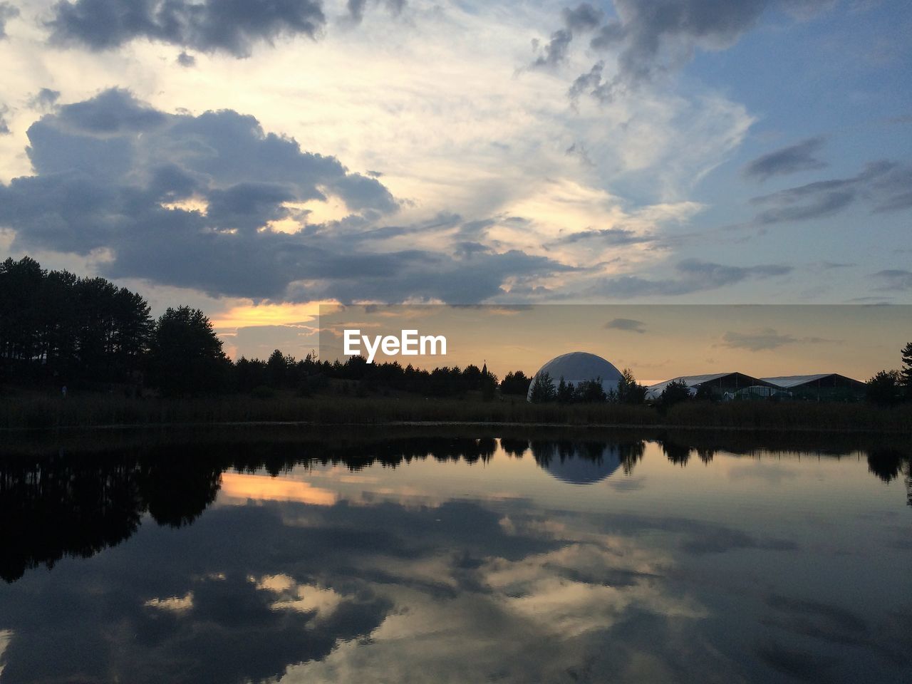 Scenic view of calm lake at sunset