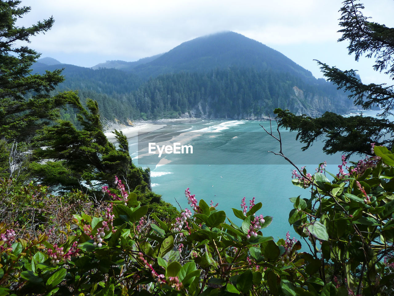 Scenic view of sea and mountains against sky