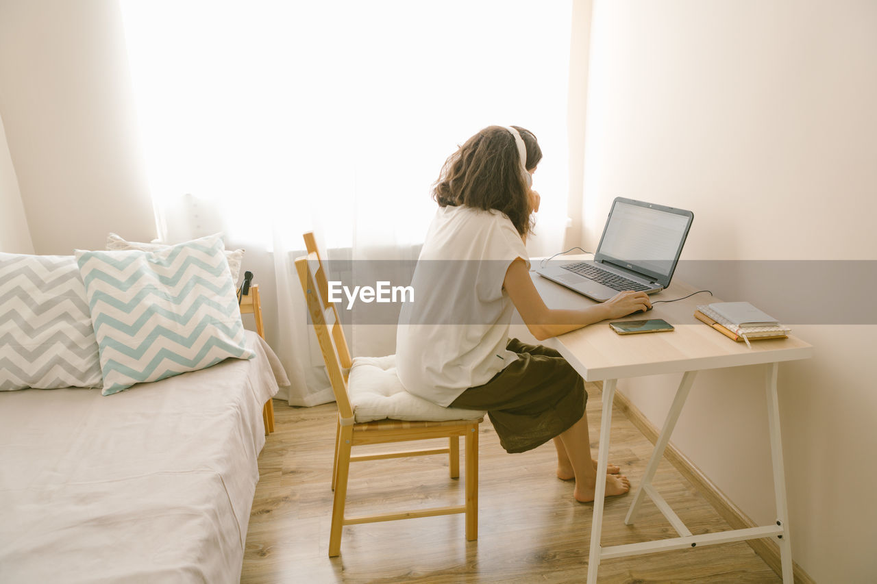 Woman using laptop at home