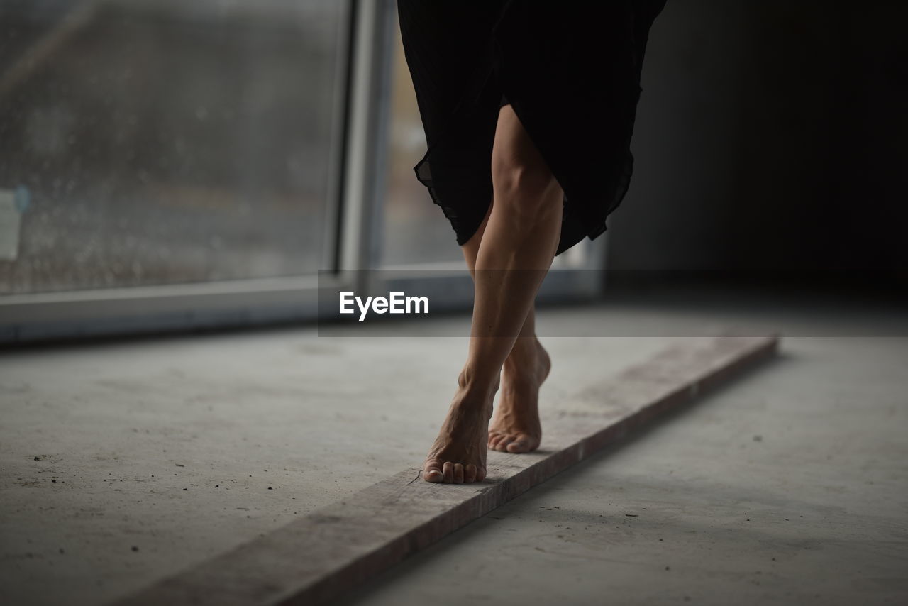 Low section of woman standing on floor