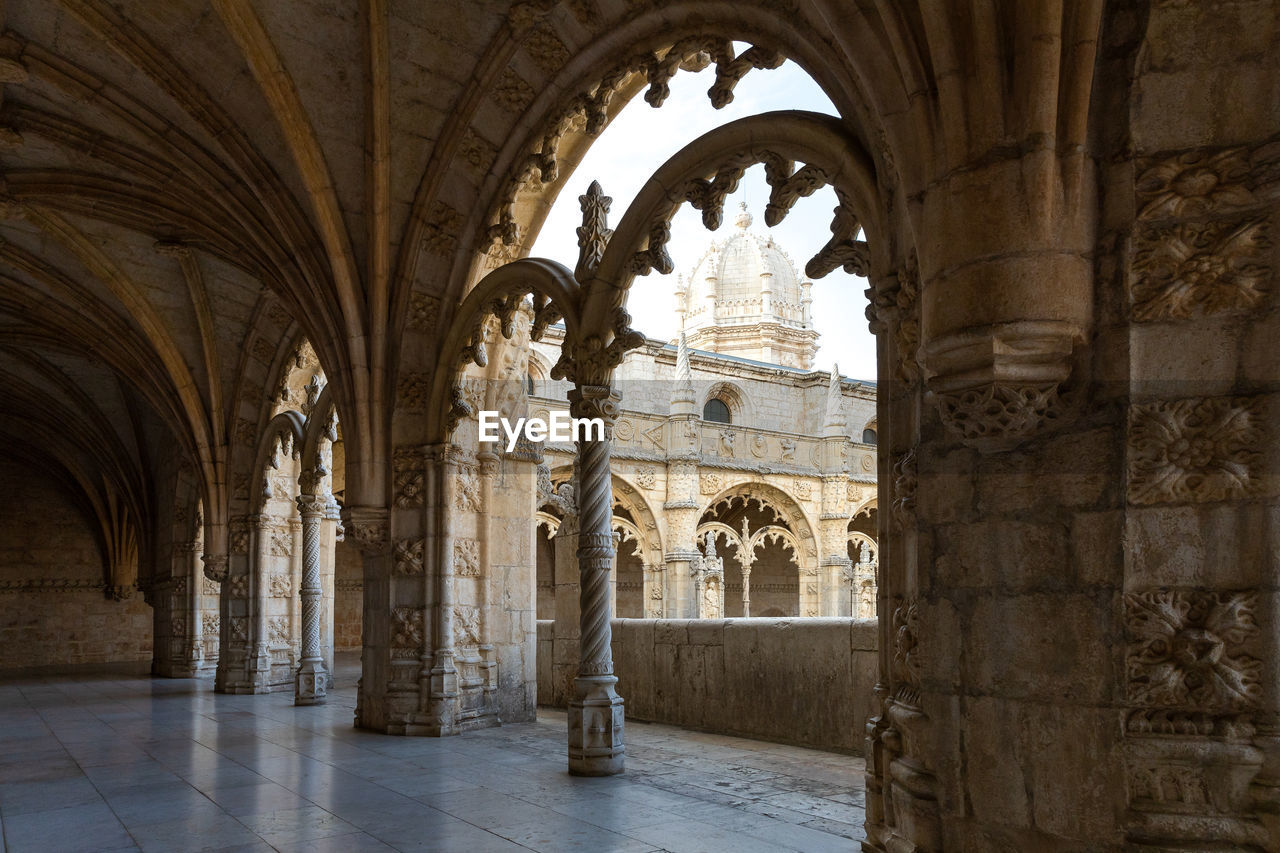 The jeronimos monastery.  the sanctuary is viewed through the detail sculpted window arches. 
