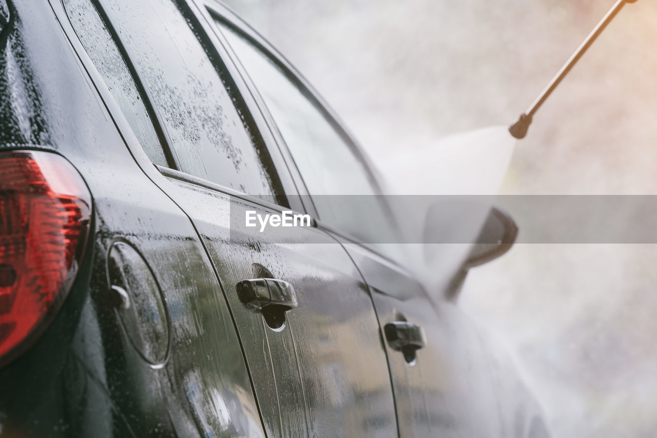 Close-up of water splashing on car 