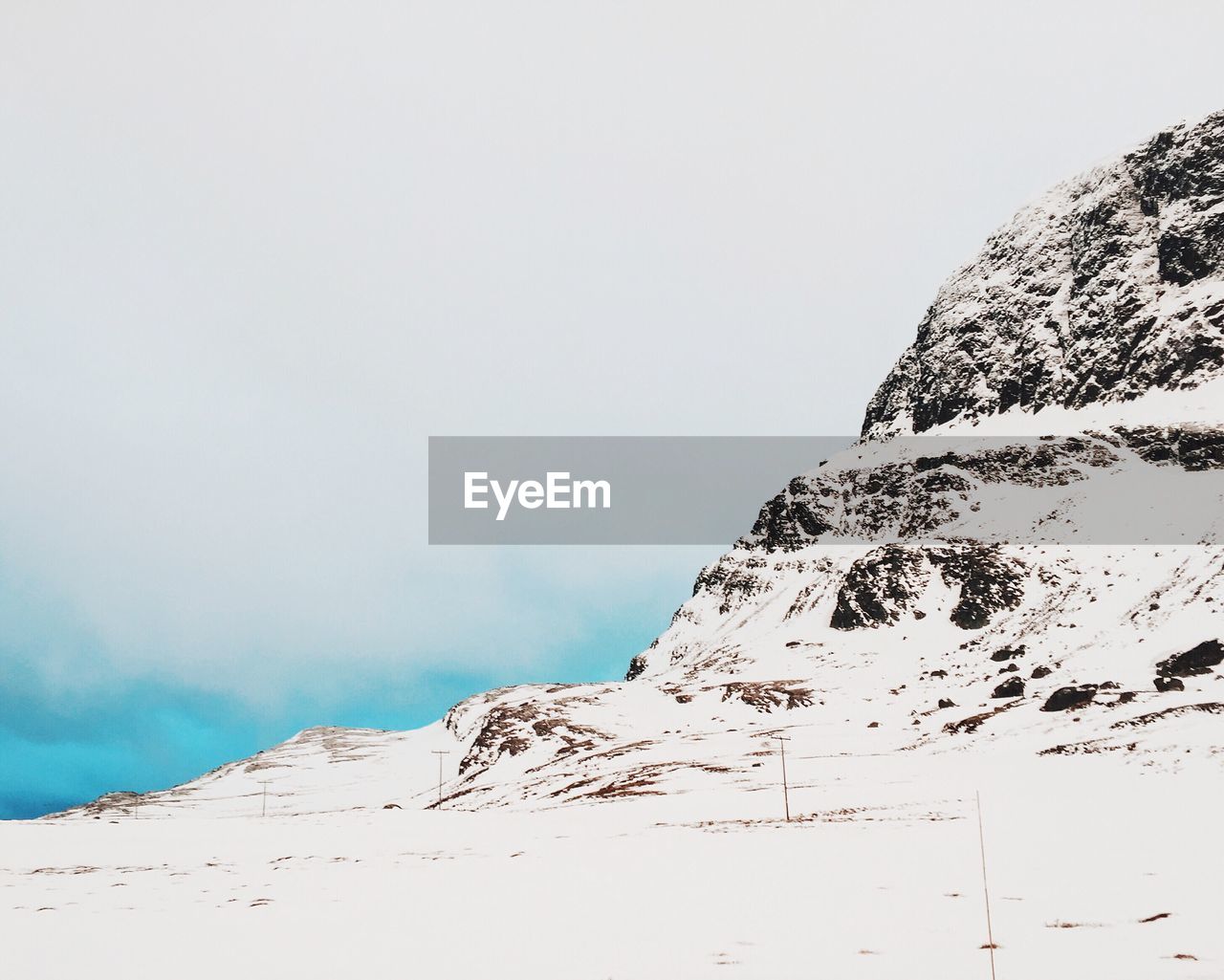 Scenic view of snow covered mountain against sky