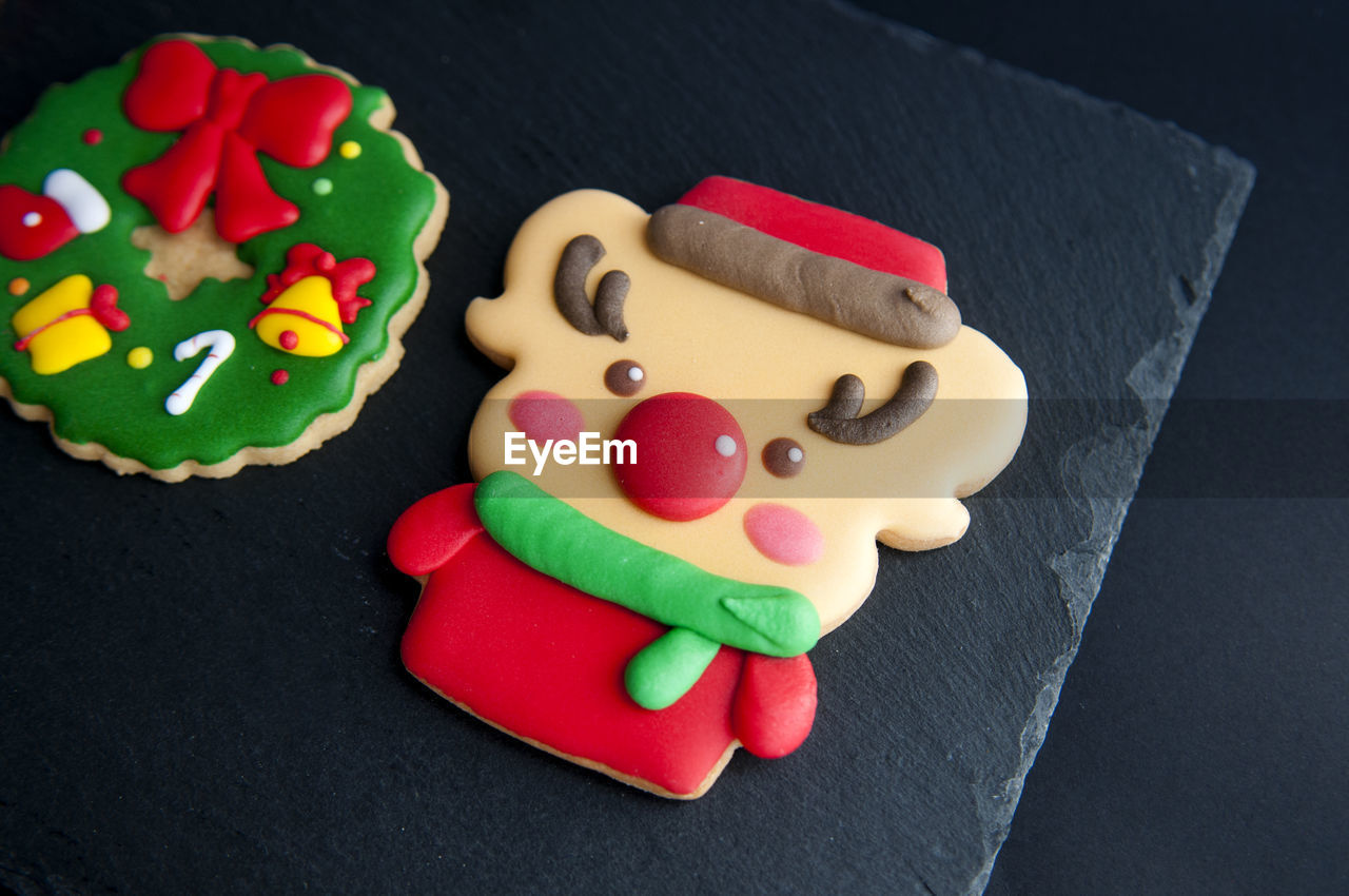 Multi colored gingerbread cookies during christmas on table